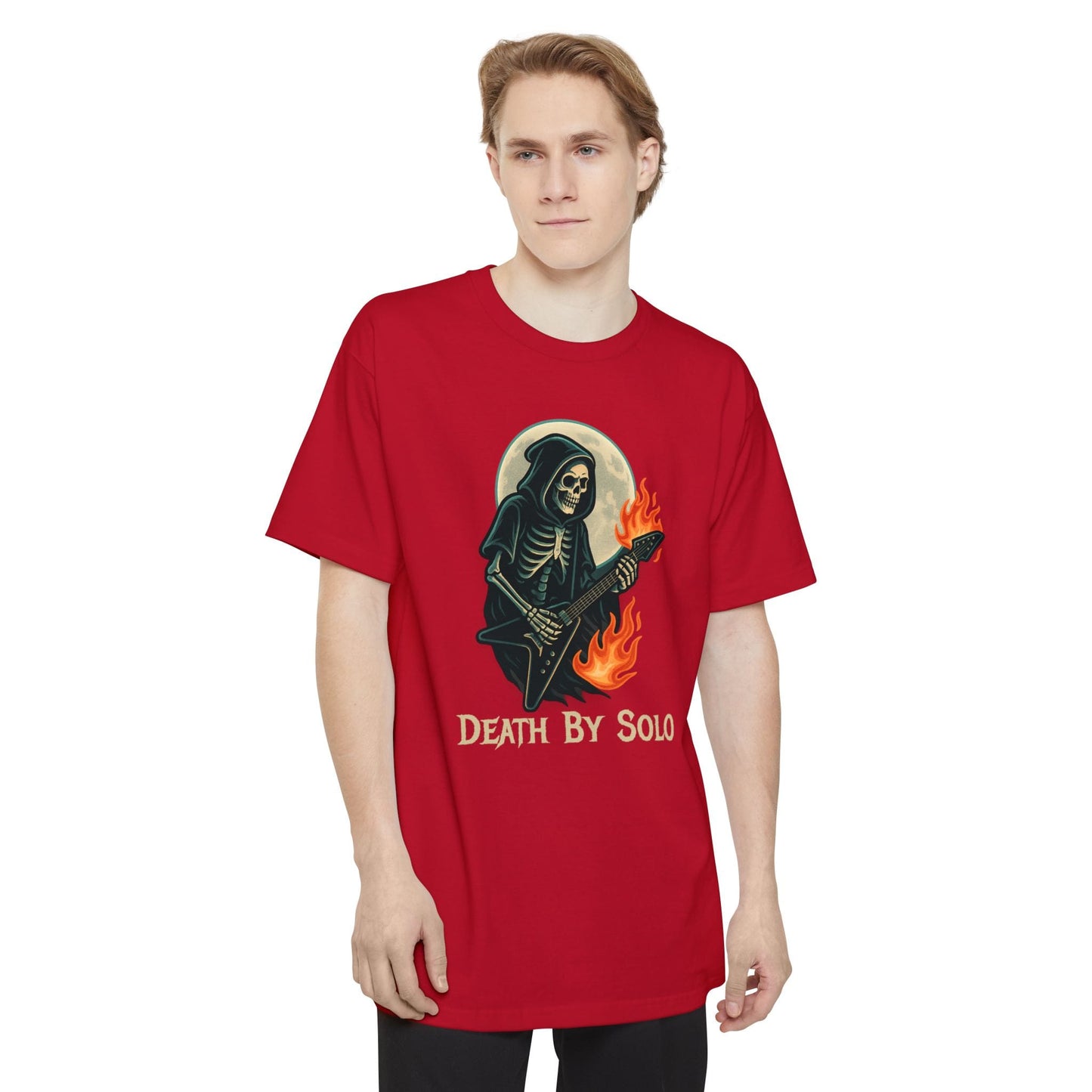 A man wearing a red short-sleeve t-shirt featuring a graphic of a grim reaper playing a guitar with flames, set against a full moon, with the text 'DEATH BY SOLO' printed below.