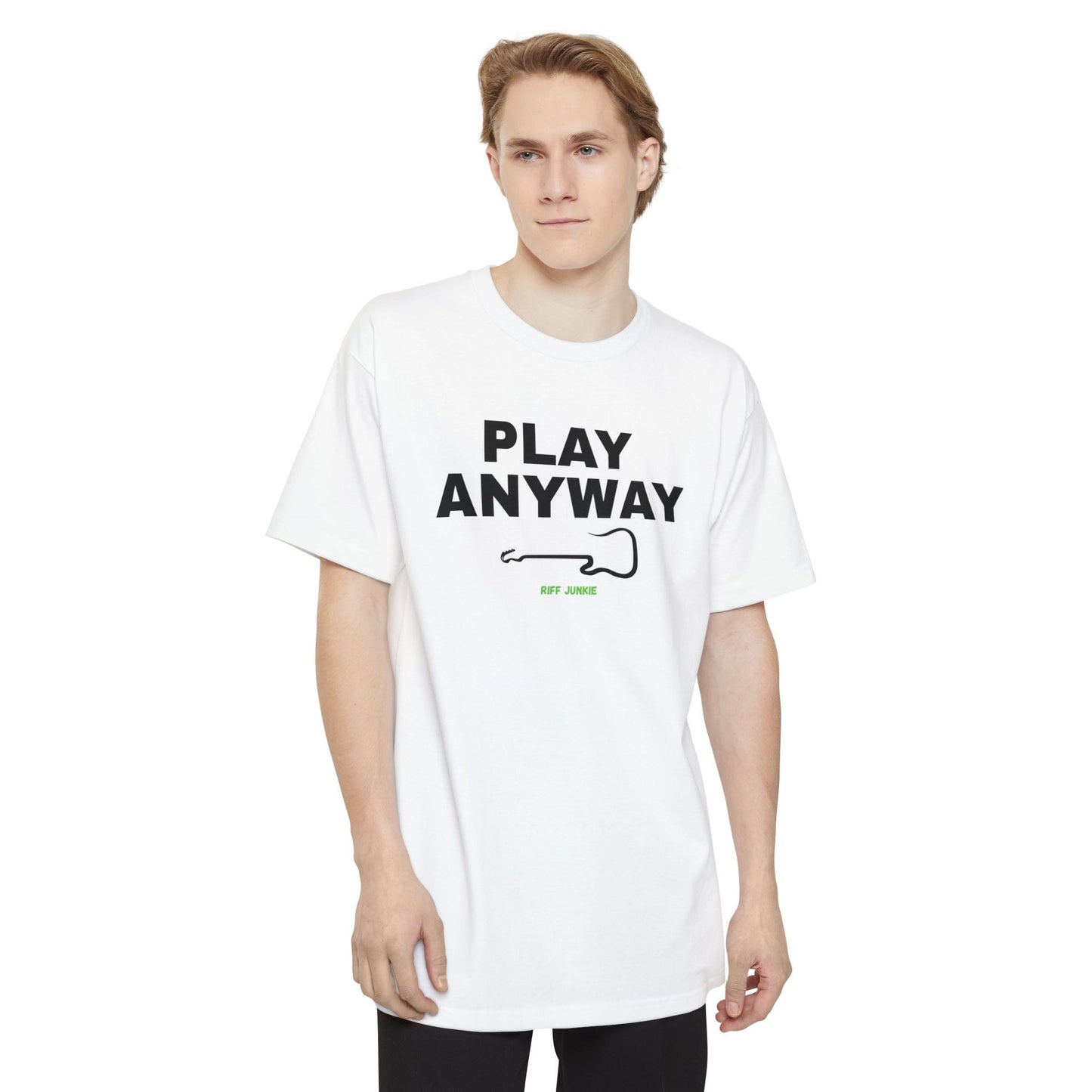 A man wearing a white short-sleeve t-shirt with a graphic on the chest that reads 'PLAY ANYWAY' in beige block letters above a beige guitar outline and small green 'Riff Junkie' text, shown on a plain white background.