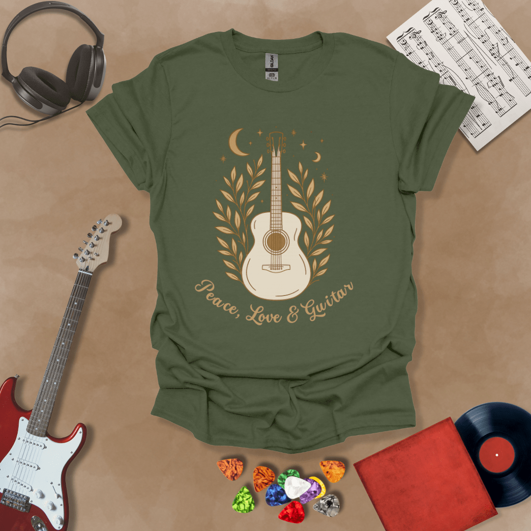 Green t-shirt featuring an acoustic guitar surrounded by leaves, moons, and stars in an earthy, bohemian line-art style, with the text “Peace, Love & Guitar” below.