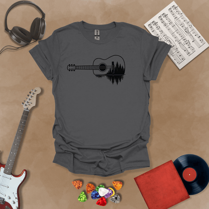 Charcoal t-shirt with a black graphic of an acoustic guitar, featuring a reflection of pine trees and water inside the guitar body.