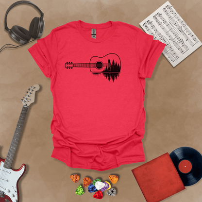 Heather Red t-shirt with a black graphic of an acoustic guitar, featuring a reflection of pine trees and water inside the guitar body.