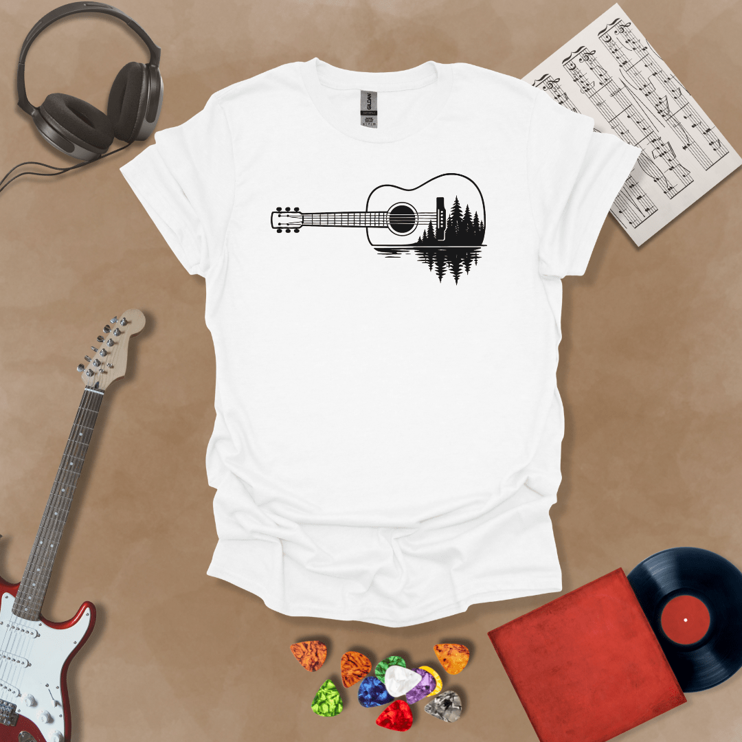 White t-shirt with a black graphic of an acoustic guitar, featuring a reflection of pine trees and water inside the guitar body.