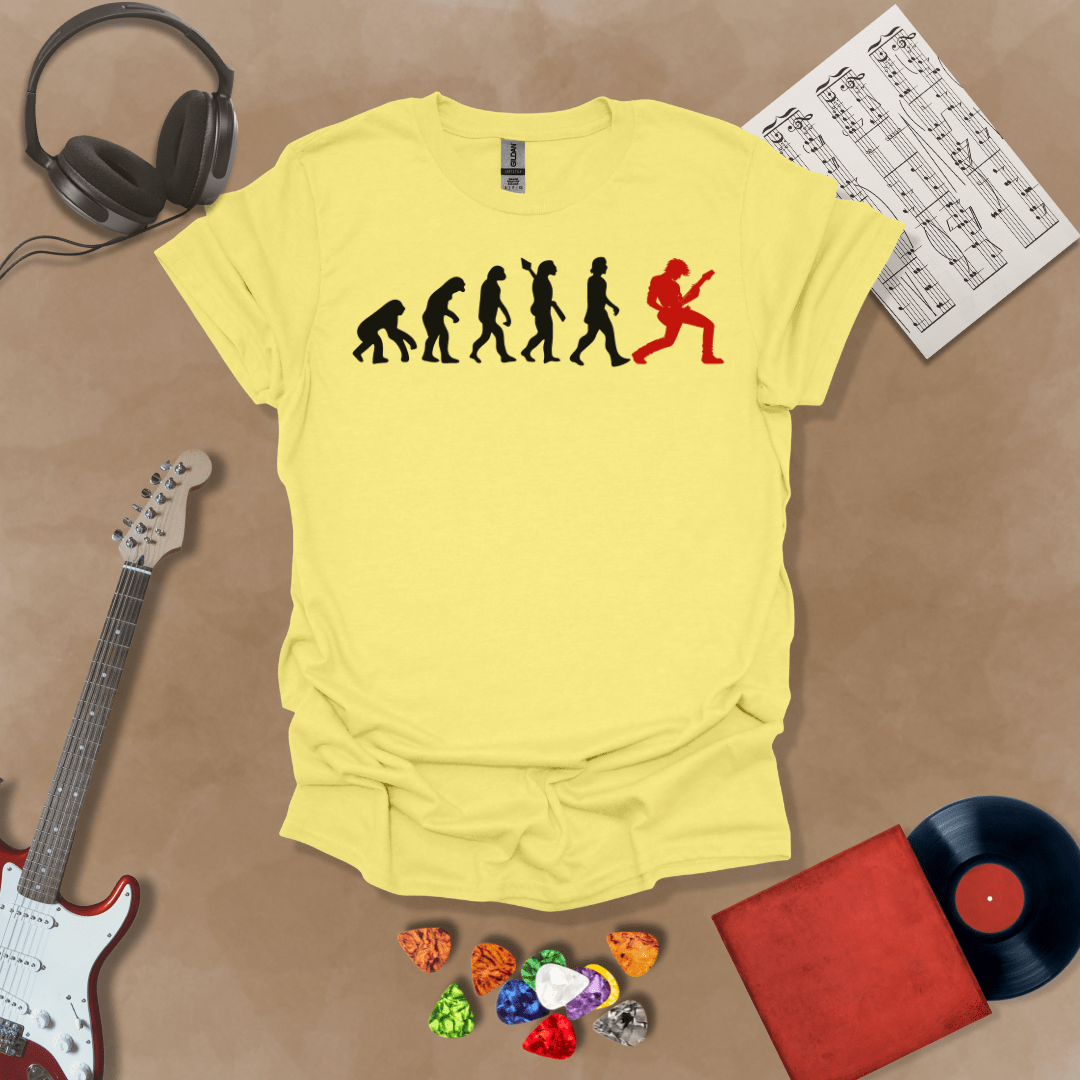 Yellow t-shirt with a black and red evolution graphic, showing the progression from ape to modern human, ending with a red silhouette of a guitarist rocking out.