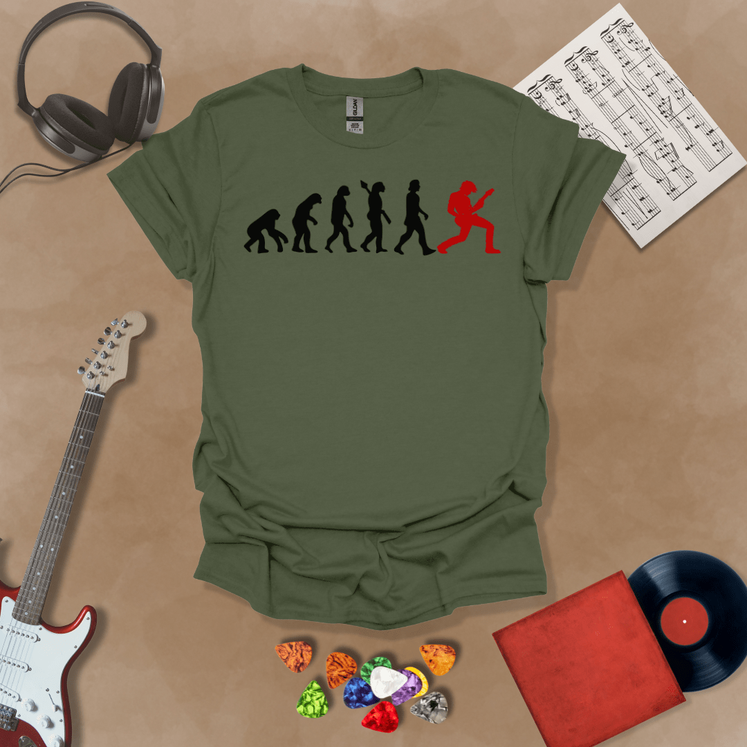 Green t-shirt with a black and red evolution graphic, showing the progression from ape to modern human, ending with a red silhouette of a guitarist rocking out.