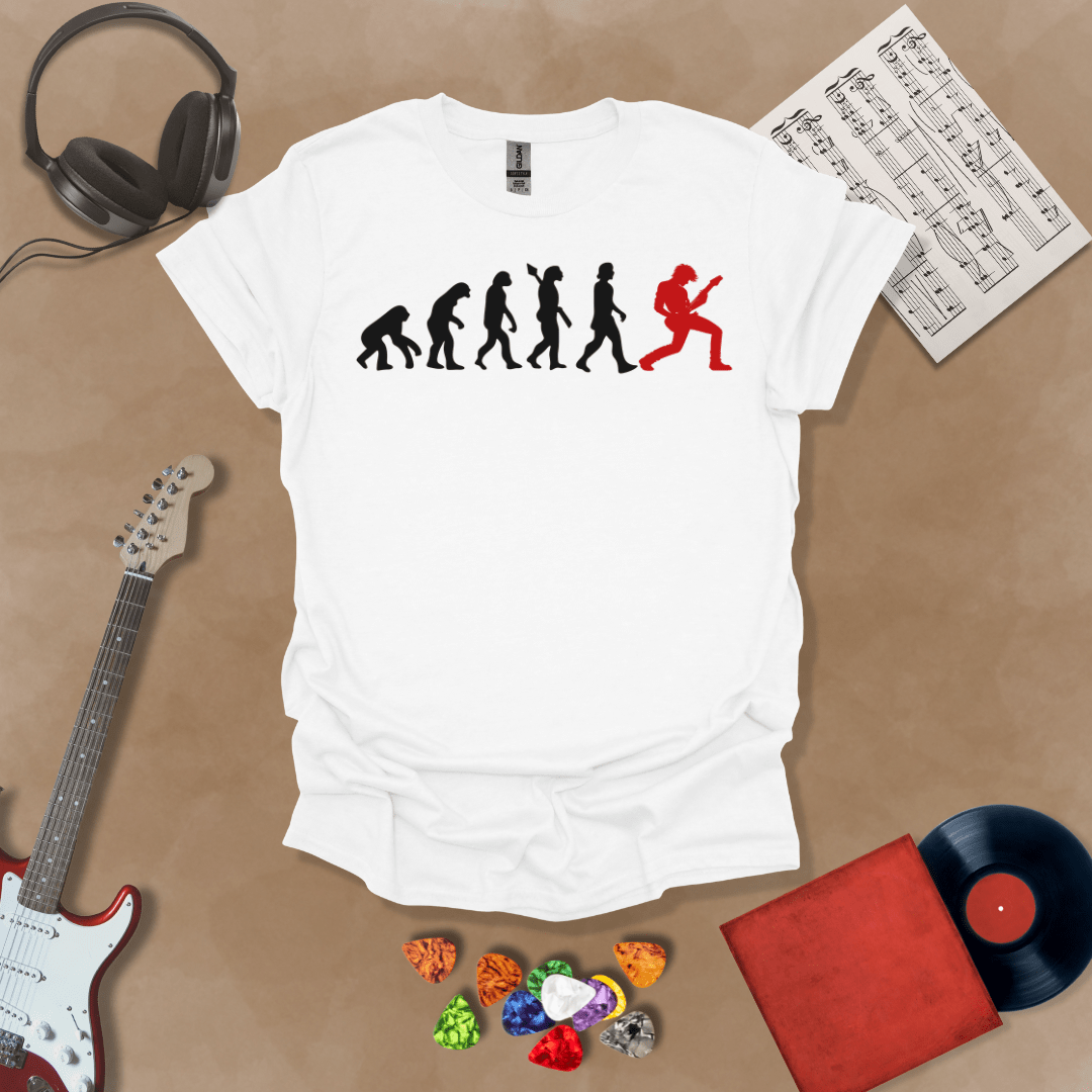 White t-shirt with a black and red evolution graphic, showing the progression from ape to modern human, ending with a red silhouette of a guitarist rocking out.
