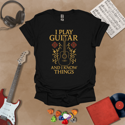 Black t-shirt with bold medieval-inspired graphic and text “I Play Guitar and I Know Things,” blending rock style with witty humor by Riff Junkie.