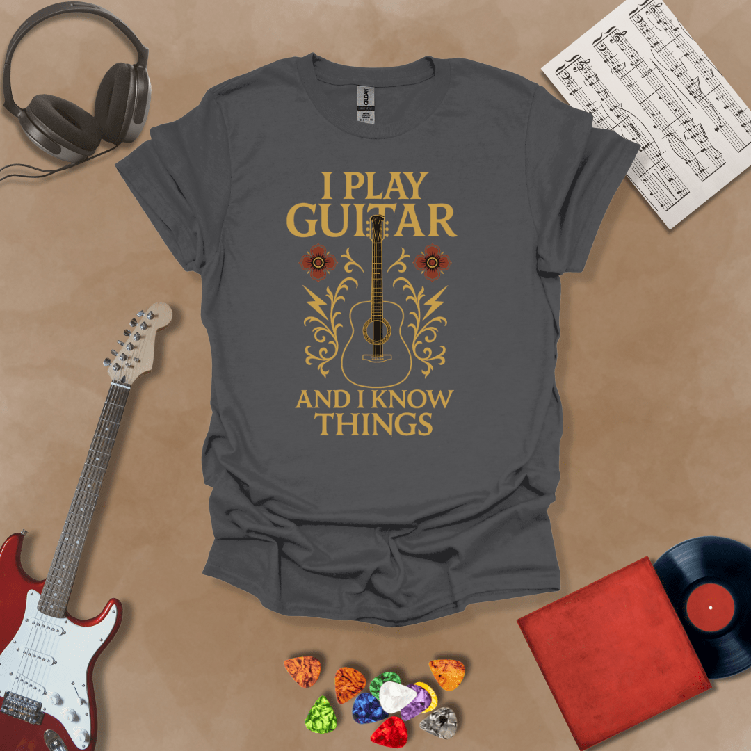 Gray t-shirt with bold medieval-inspired graphic and text “I Play Guitar and I Know Things,” blending rock style with witty humor by Riff Junkie.