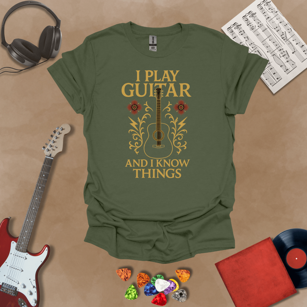 Green t-shirt with bold medieval-inspired graphic and text “I Play Guitar and I Know Things,” blending rock style with witty humor by Riff Junkie.
