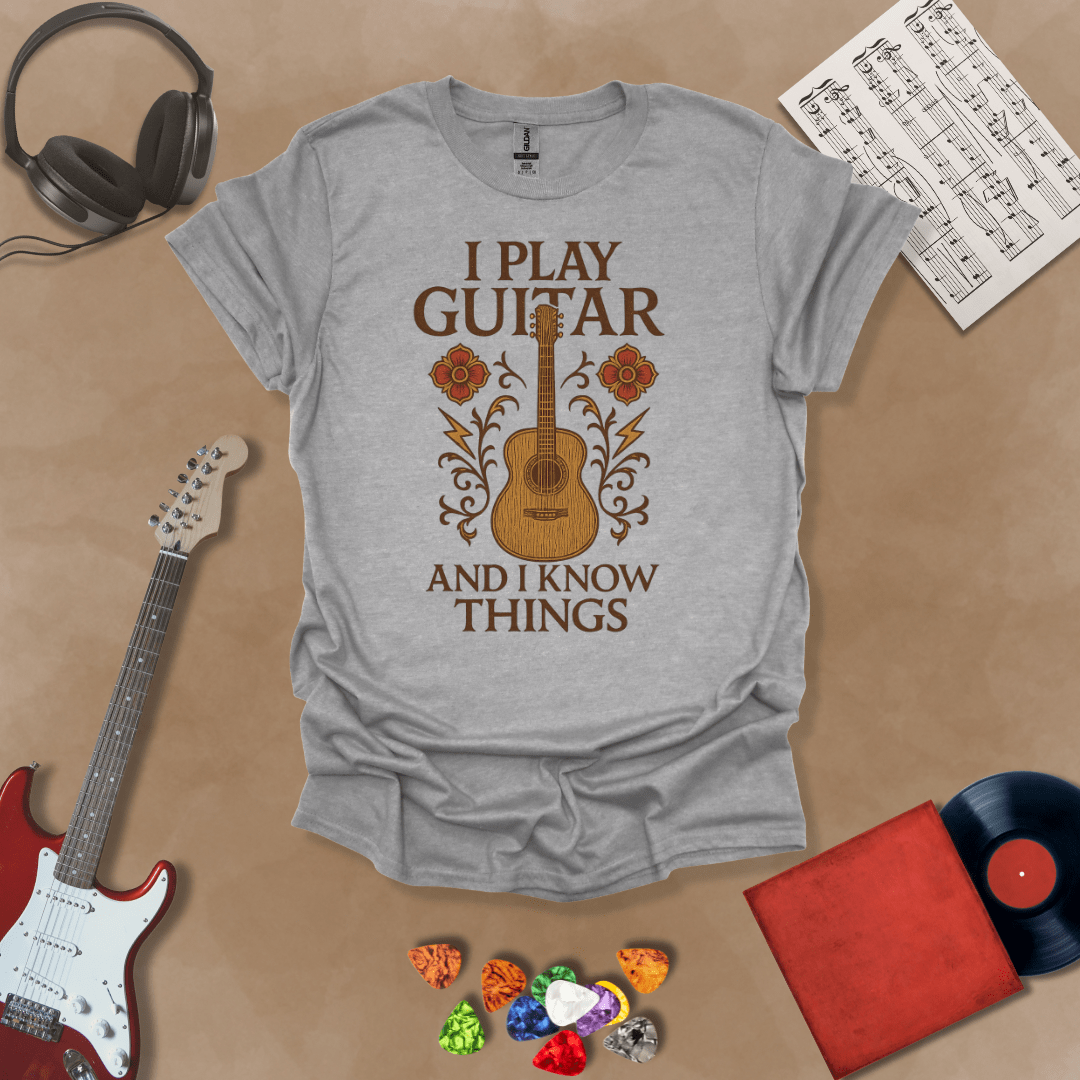 Gray t-shirt with bold medieval-inspired graphic and text “I Play Guitar and I Know Things,” blending rock style with witty humor by Riff Junkie.