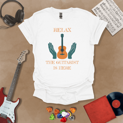 White t-shirt with Acoustic guitar with hands and text 'Relax the guitarist is here'
