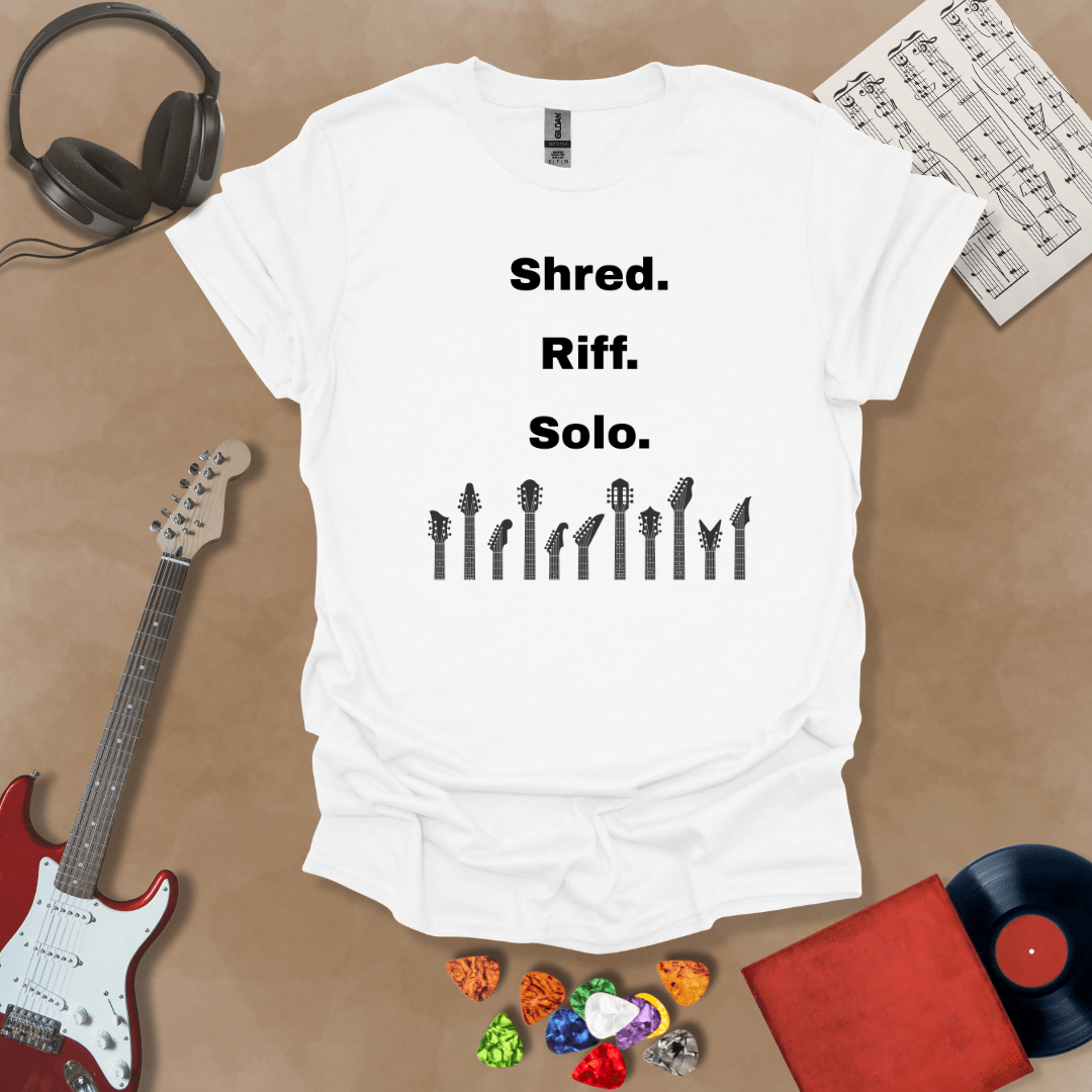 White  T-shirt with text 'Shred. Riff. Solo.' with row of guitar headstocks silhouette