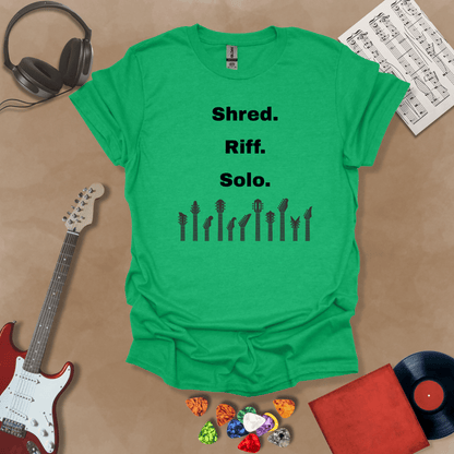 Green T-shirt with text 'Shred. Riff. Solo.' with row of guitar headstocks silhouette