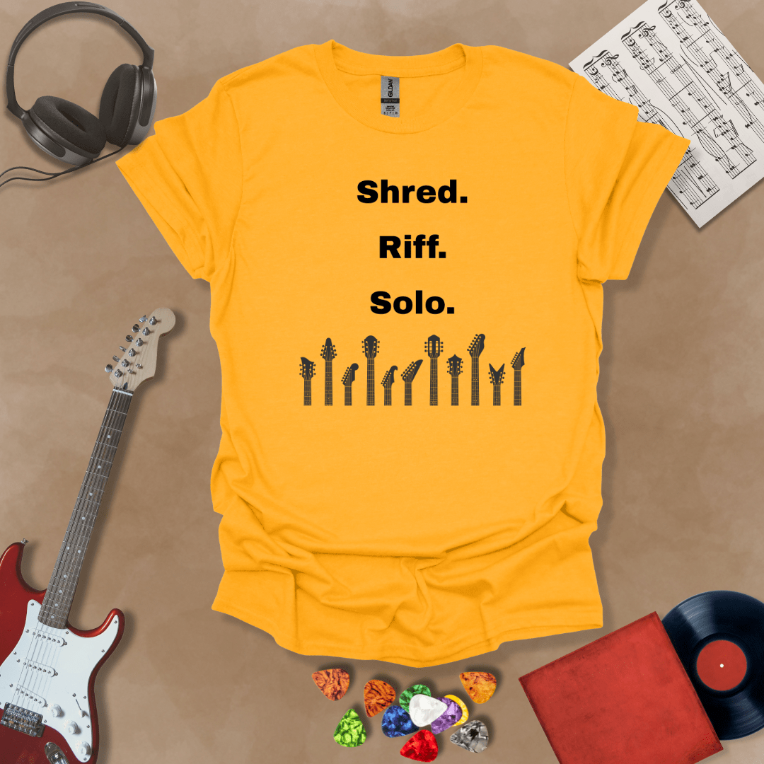 Yellow T-shirt with text 'Shred. Riff. Solo.' with row of guitar headstocks silhouette