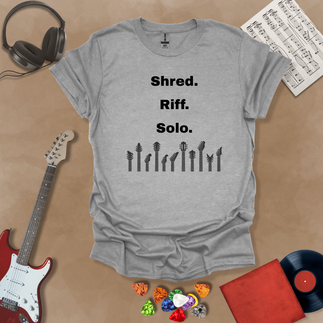 Gray T-shirt with text 'Shred. Riff. Solo.' with row of guitar headstocks silhouette