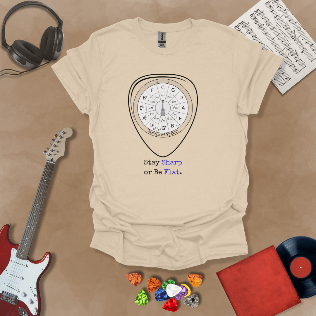 Beige t-shirt with Circle of fifths chart inside guitar pick, text 'Stay sharp or be flat'