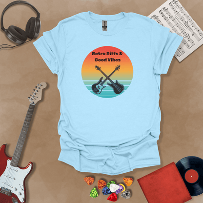 Light Blue t-shirt with Two guitars crossed in front of sunset, text 'Retro Riffs & Good Vibes'