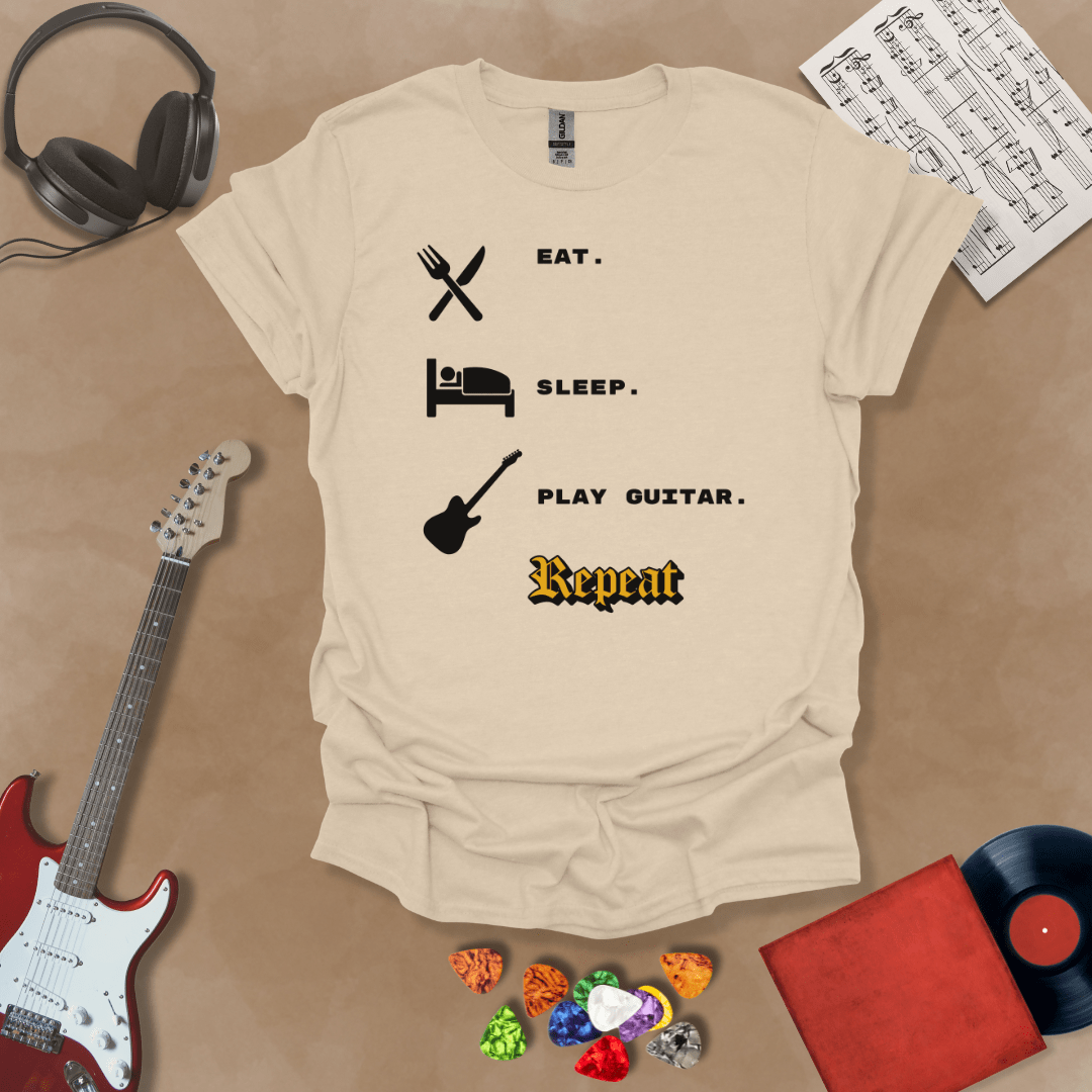 Beige t-shirt with 'Eat. Sleep. Play Guitar. Repeat.' text and graphics 