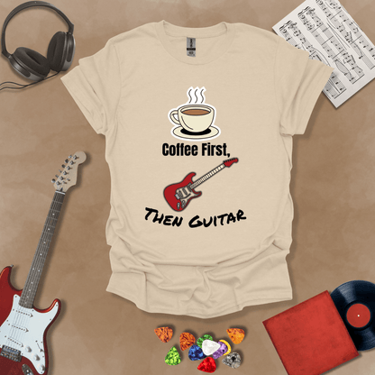Beige T-shirt design with steaming coffee cup illustration transforming into guitar strings, text “Coffee First, Then Guitar.”e
