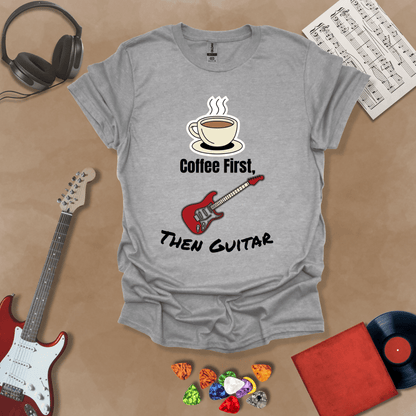 Gray T-shirt design with steaming coffee cup illustration transforming into guitar strings, text “Coffee First, Then Guitar.”