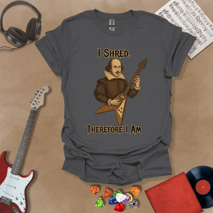 Medieval-inspired gray t-shirt with bold lettering “I Shred, Therefore I Am” and guitar art.