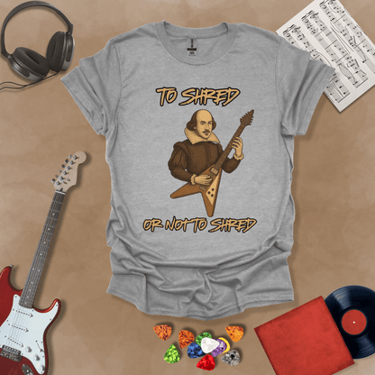 Gray Shakespeare-inspired t-shirt design with text “To Shred or Not to Shred,” paired with guitar artwork.