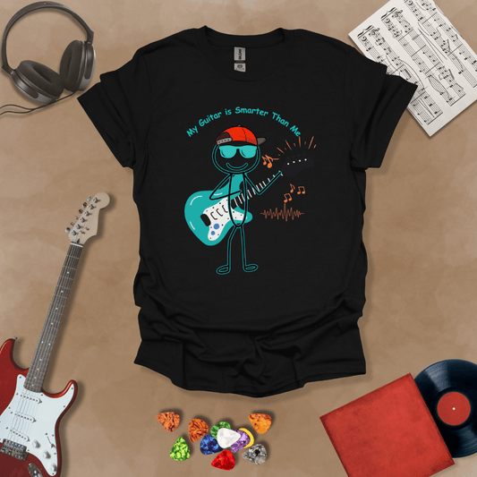 Black t-shirt with cartoon stick figure wearing hat and sunglasses, holding teal guitar, text “My Guitar is Smarter Than Me.”
