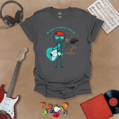 Gray t-shirt with cartoon stick figure wearing hat and sunglasses, holding teal guitar, text “My Guitar is Smarter Than Me.”
