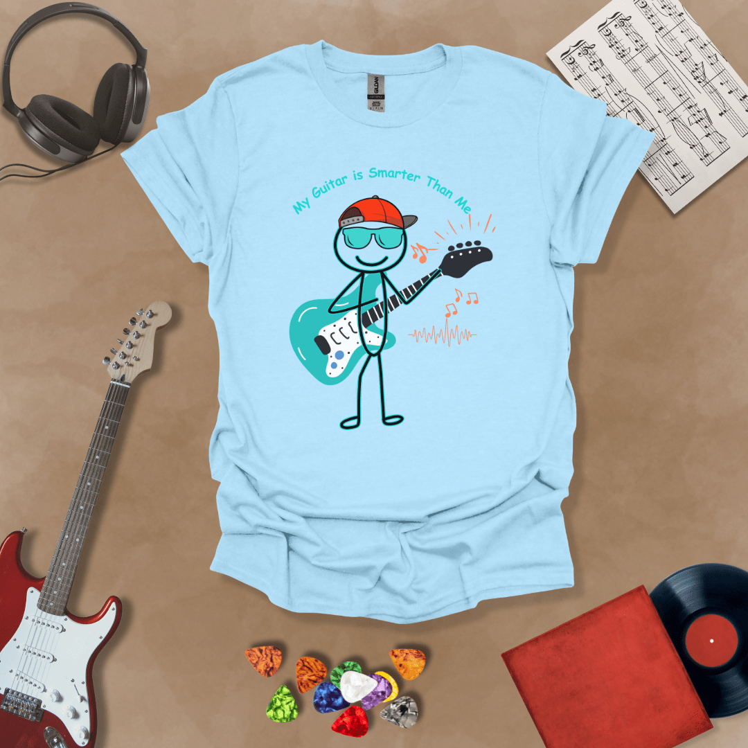 Light blue t-shirt with cartoon stick figure wearing hat and sunglasses, holding teal guitar, text “My Guitar is Smarter Than Me.”
