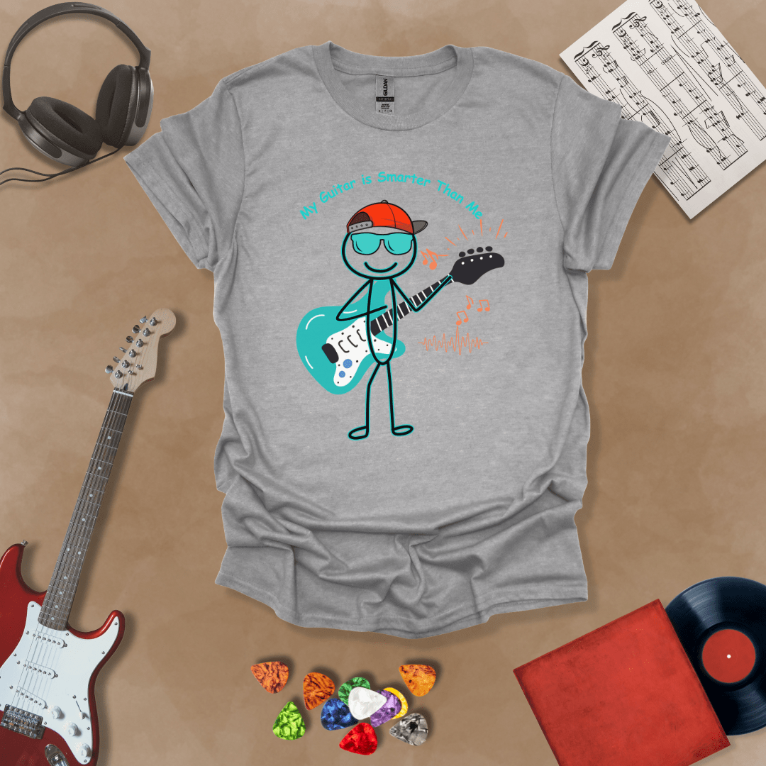 Gray t-shirt with cartoon stick figure wearing hat and sunglasses, holding teal guitar, text “My Guitar is Smarter Than Me.”
