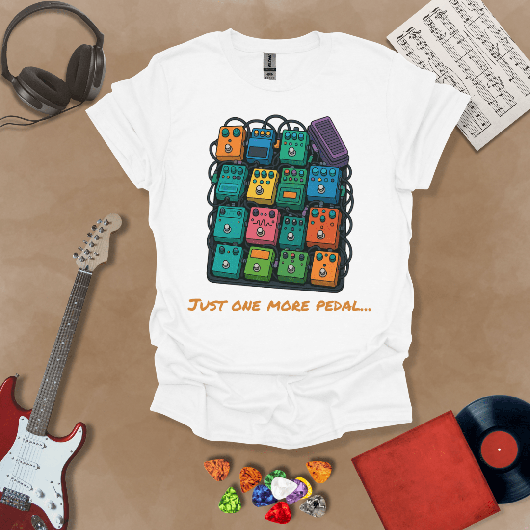 White t-shirt with graphic of multiple guitar pedals, text “Just One More Pedal.”