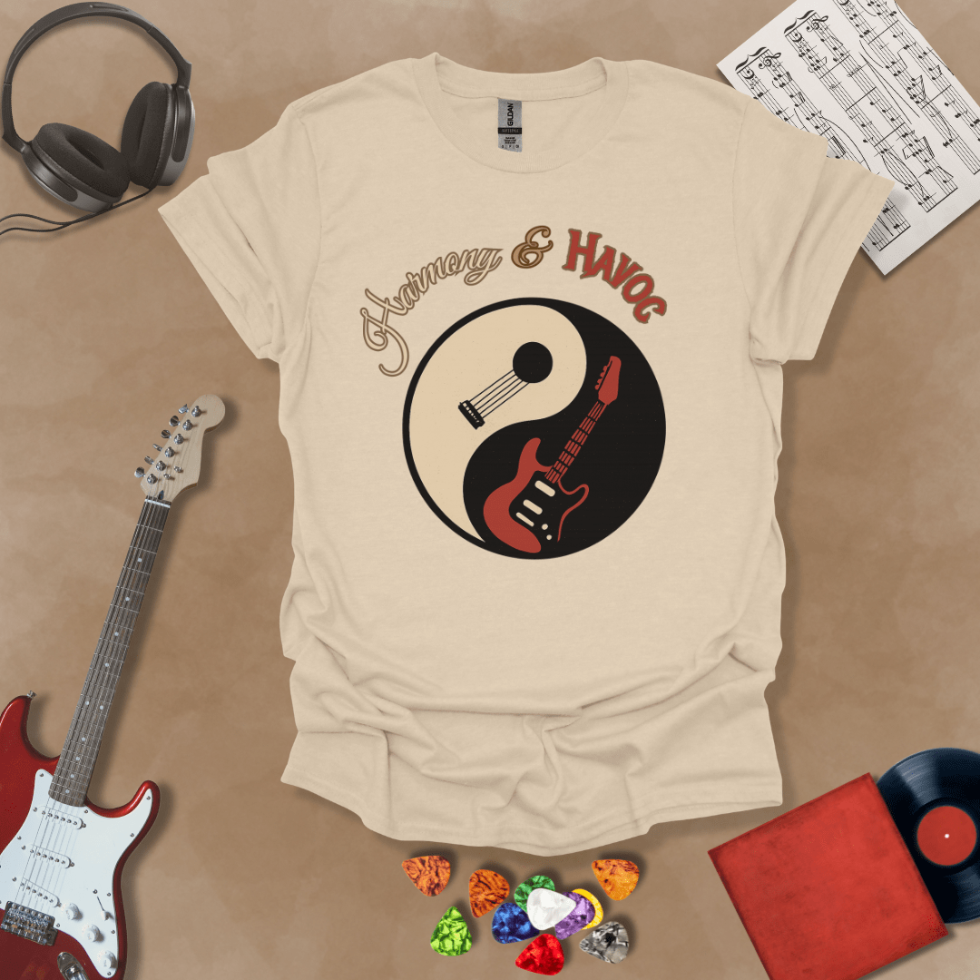 Beige t-shirt with yin-yang design made from an acoustic and electric guitar, text “Harmony & Havoc.”