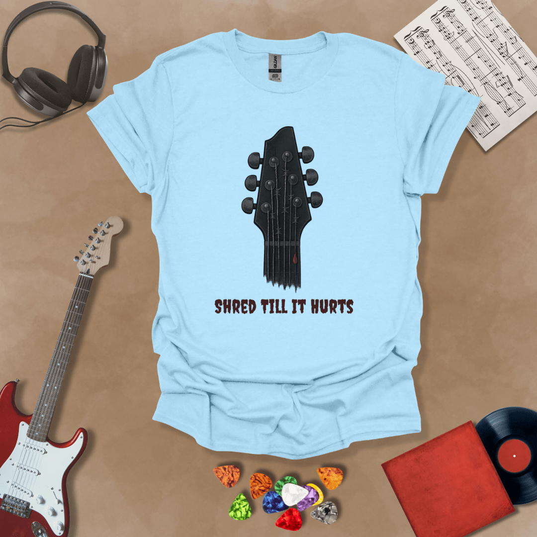 Light Blue t-shirt with distressed guitar graphic, text “Shred ’Til It Hurts.”