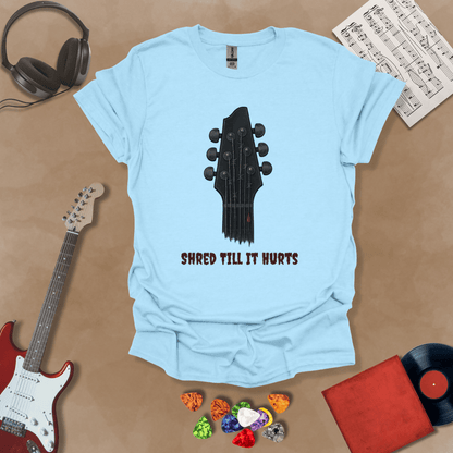 Light Blue t-shirt with distressed guitar graphic, text “Shred ’Til It Hurts.”