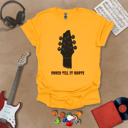 Yellow t-shirt with distressed guitar graphic, text “Shred ’Til It Hurts.”
