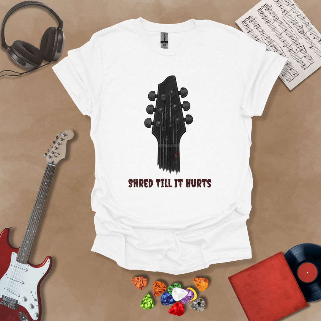 White t-shirt with distressed guitar graphic, text “Shred ’Til It Hurts.”
