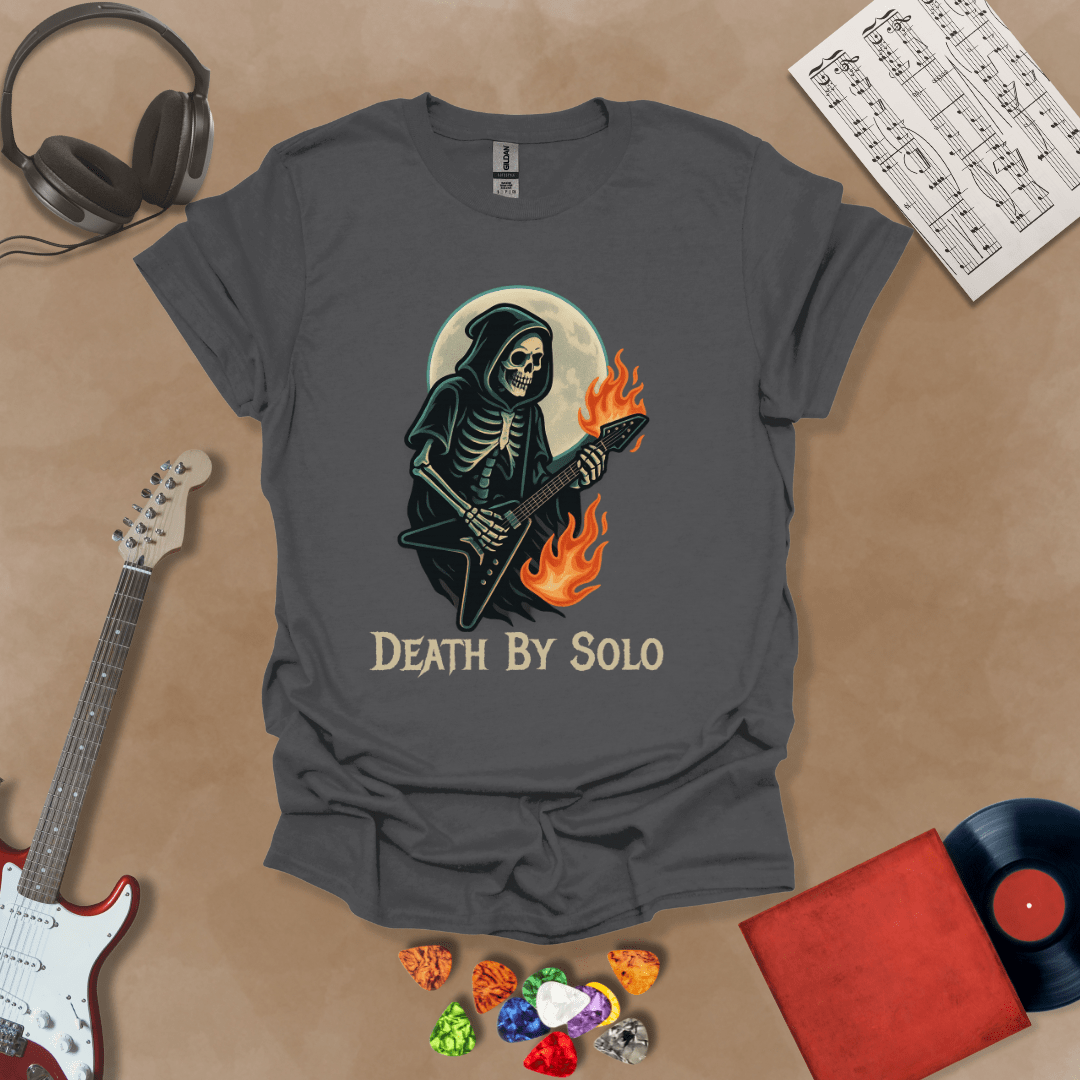 Gray t-shirt with a graphic of a grim reaper skeleton playing a flaming V-style guitar under a glowing full moon, with the text “Death By Solo” below.

