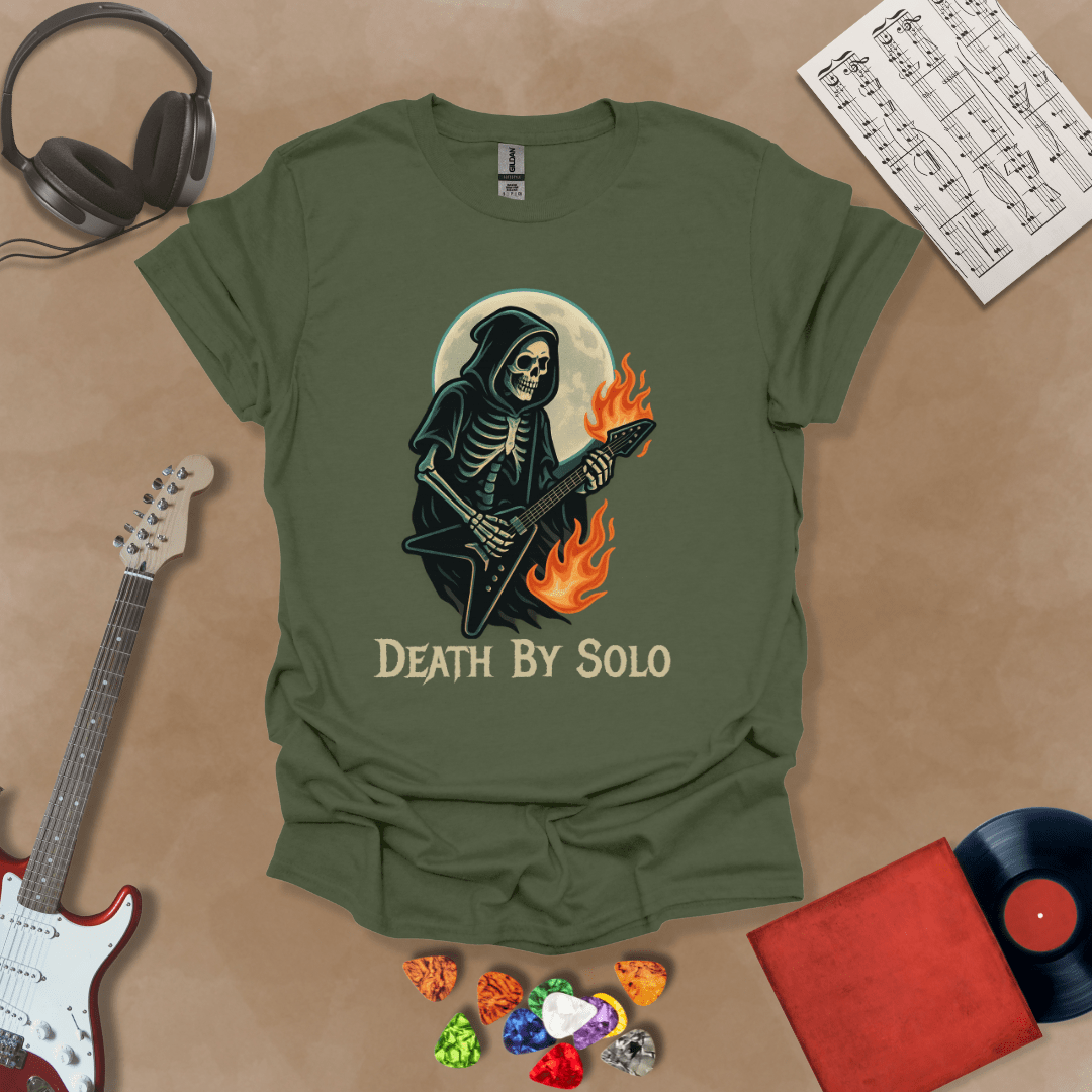 Green t-shirt with a graphic of a grim reaper skeleton playing a flaming V-style guitar under a glowing full moon, with the text “Death By Solo” below.
