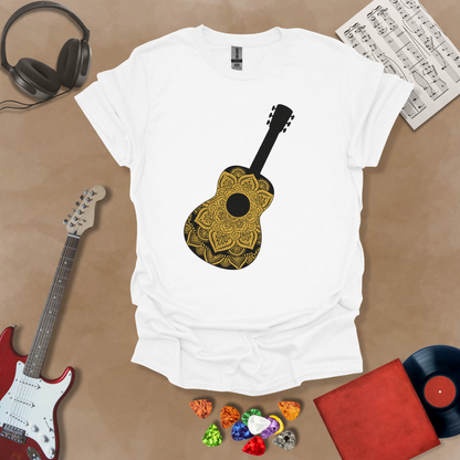 White t-shirt with mandala pattern shaped like guitar body.
