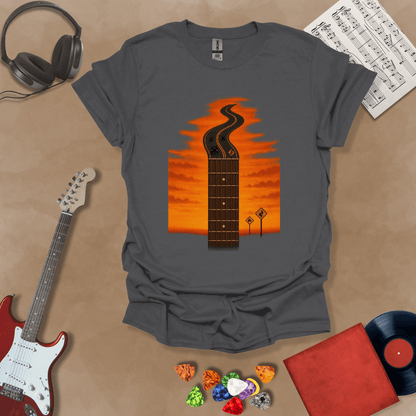 Gray t-shirt with long guitar neck blending into a road under sunset sky.
