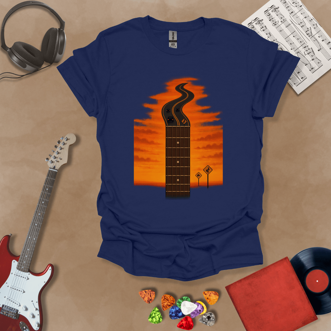 Navy t-shirt with long guitar neck blending into a road under sunset sky.
