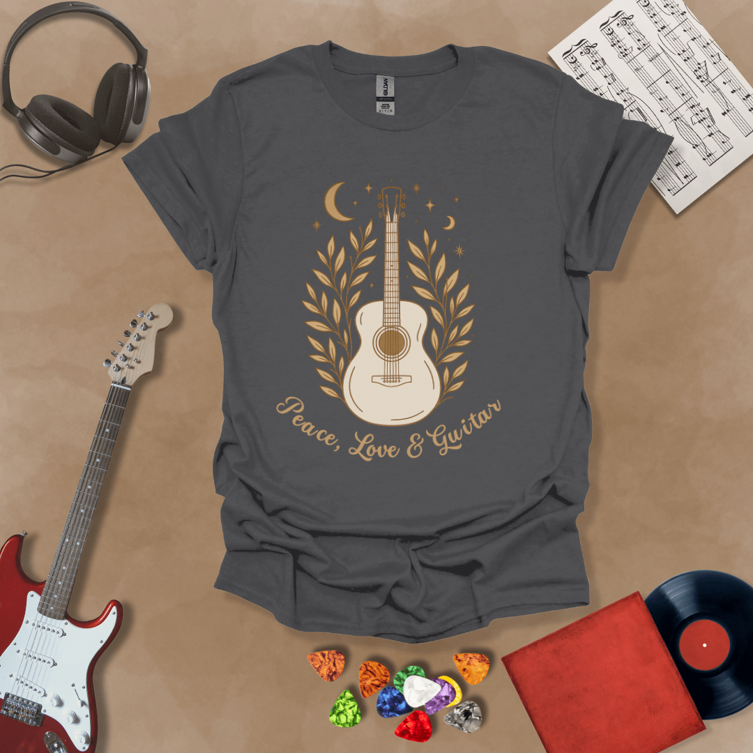 Gray t-shirt featuring an acoustic guitar surrounded by leaves, moons, and stars in an earthy, bohemian line-art style, with the text “Peace, Love & Guitar” below.
