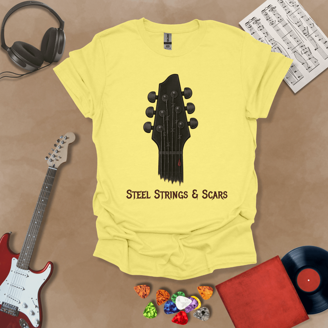 Yellow t-shirt featuring a guitar headstock with razor-wire steel strings and a drop of blood, with the text “Steel Strings & Scars” below.
