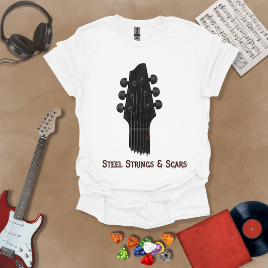 White t-shirt featuring a guitar headstock with razor-wire steel strings and a drop of blood, with the text “Steel Strings & Scars” below.
