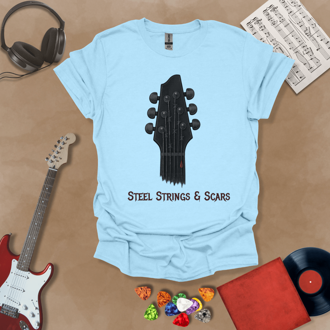 Light Blue t-shirt featuring a guitar headstock with razor-wire steel strings and a drop of blood, with the text “Steel Strings & Scars” below.
