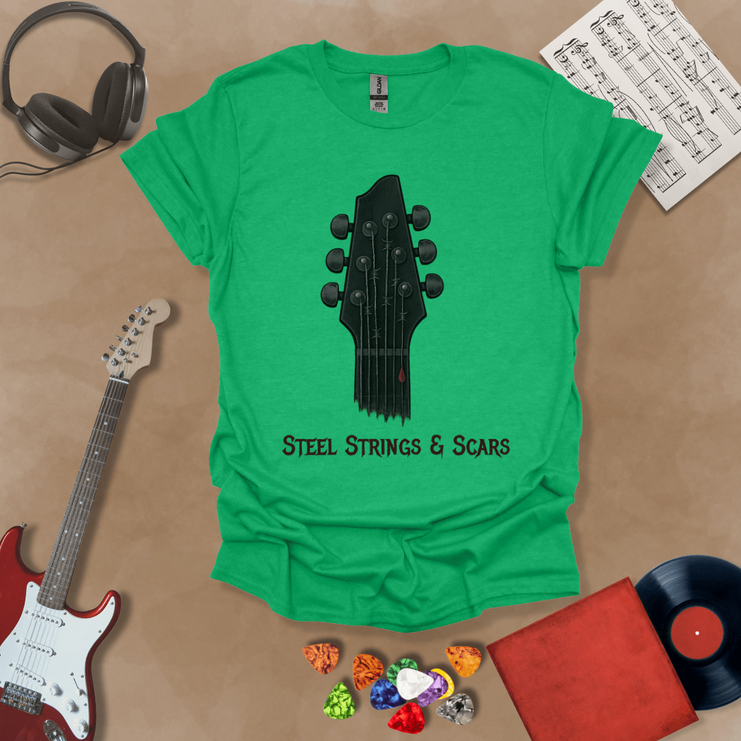 Green t-shirt featuring a guitar headstock with razor-wire steel strings and a drop of blood, with the text “Steel Strings & Scars” below.
