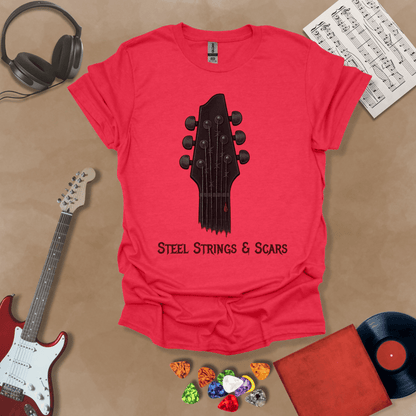 Red t-shirt featuring a guitar headstock with razor-wire steel strings and a drop of blood, with the text “Steel Strings & Scars” below.
