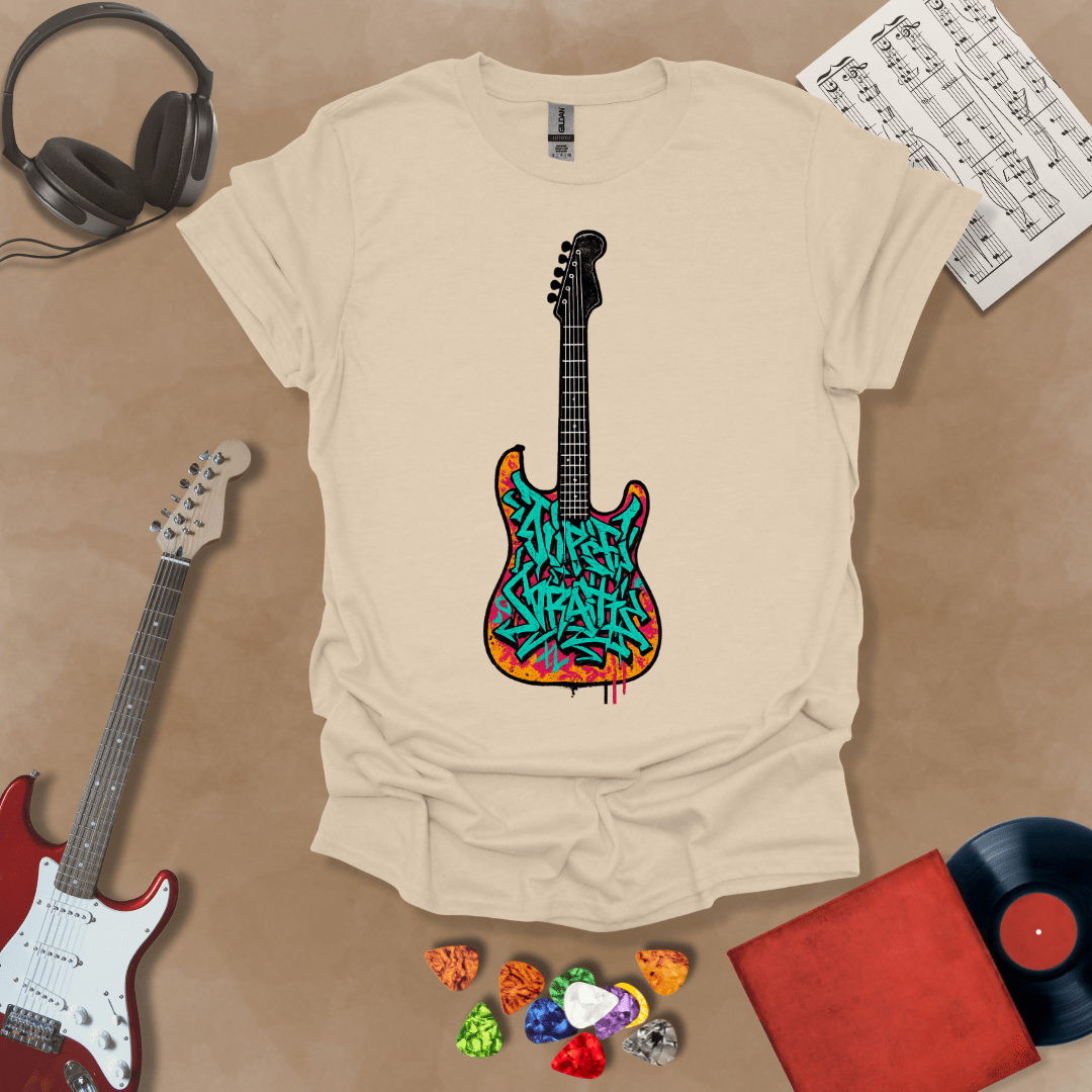 Beige t-shirt featuring an electric guitar filled with colorful graffiti-style lettering and street art textures.
