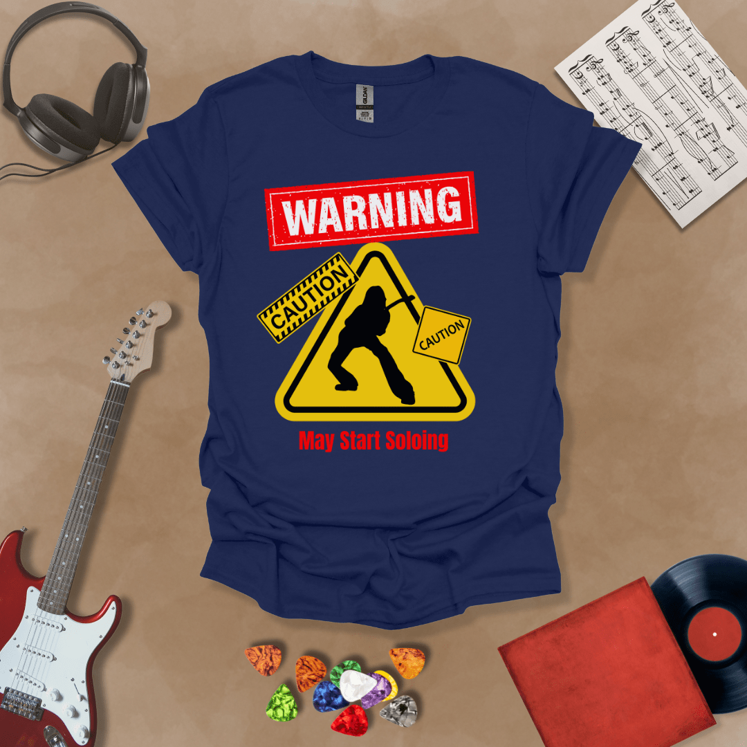 Navy t-shirt with bold red “Warning” text, yellow caution triangle with guitarist silhouette, text “May Start Soloing.”
