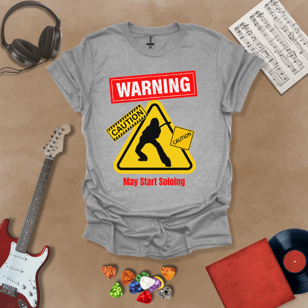 Gray t-shirt with bold red “Warning” text, yellow caution triangle with guitarist silhouette, text “May Start Soloing.”
