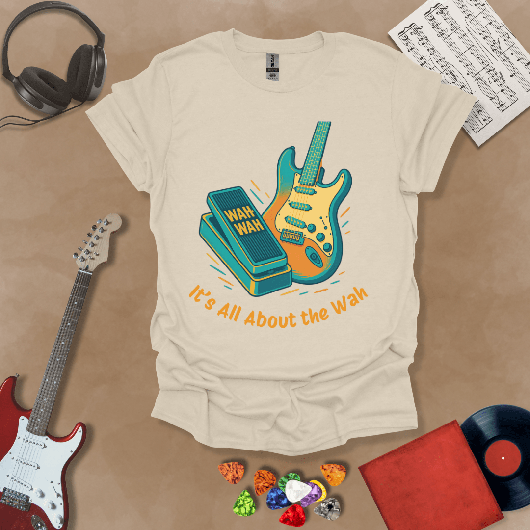 Beige t-shirt with bright color graphic guitar and wah wah pedal with text "It's all about the wah". 